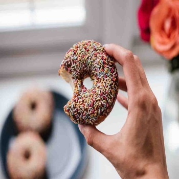 PERSON HOLDING DOUGHNUT
