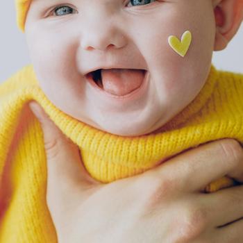 Baby in Yellow Knit Cap and Yellow Knit Sweater