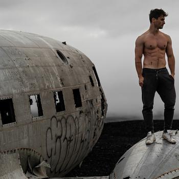 Man Standing On Airplane Wreckage