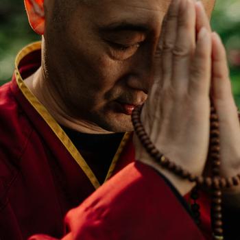 A Monk in Red Robe Praying