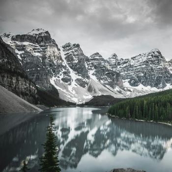 Lake near snow covered mountain under cloudy sky - HD