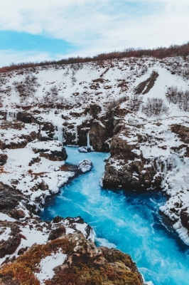 Bright wavy river between snowy mountains  cloudy sky HD WAL